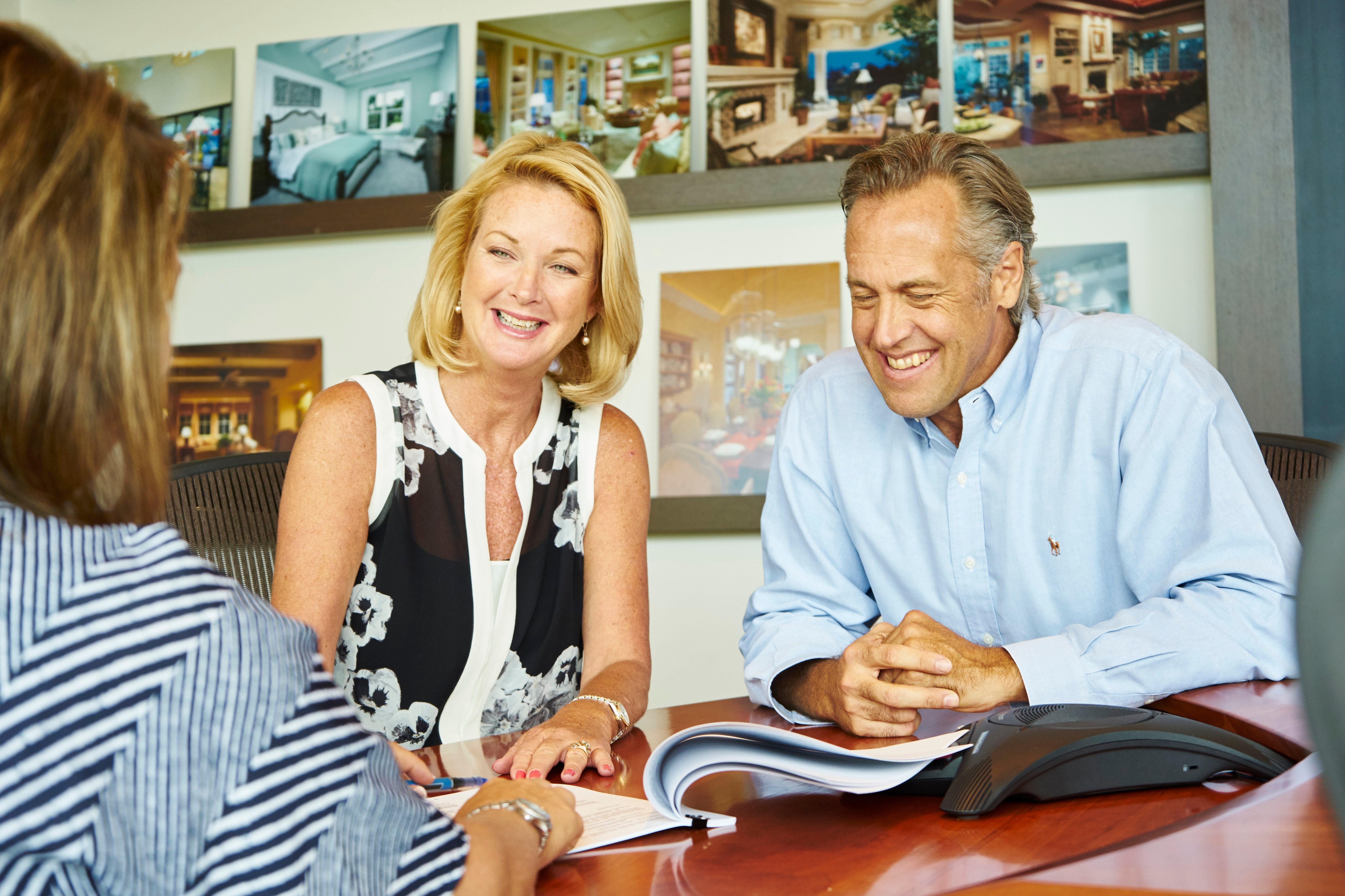  couple looking at building custom homes catalogue